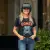 Photo : Odile N (femme) souriante, portant le t-shirt gamer geek, avec un casque VR à ses côtés.