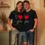 Un couple d'âge moyen souriant, peut-être enlacé, portant chacun le tee shirt "I love you" dans un cadre chaleureux, comme à la maison ou lors d'une escapade romantique.
