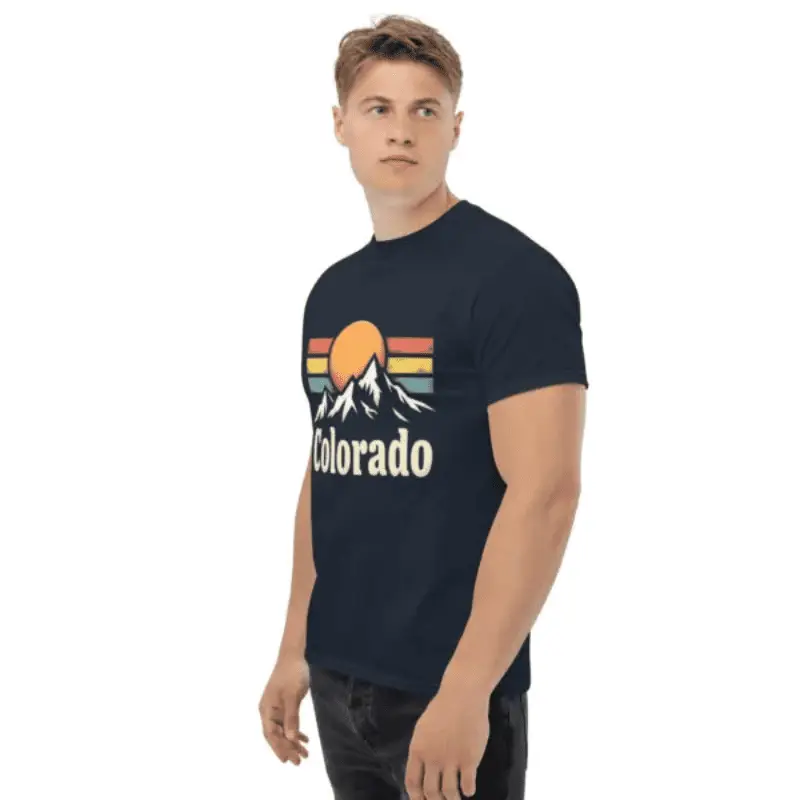 Homme de profil arborant un t-shirt unisexe classique colorado vibes bleu marine.